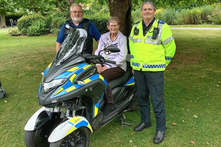 The Mayor of Wellington, Cllr Janet Lloyd, aboard the three-wheeled police motorcycle along with PCSOs Simon Bramley (left) and Steve Hill. (Photo: Wellington Town Council)
